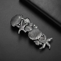 Pasador de pelo vintage plateado con estrella de mar y conchas sobre fondo oscuro - Plata Antigua