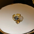 Macro shot of vintage gold-plated ring with faceted crystal, amber stone, and zircon ball - 31# Gold Grey Amber Composite Gemstone Open Ring