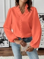Detailed close-up of orange long-sleeved shirt with ruffle V-neck and silky texture - S / Tops / Orange