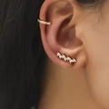 Macro shot of gold-plated ear cuff and crawler earrings set with brilliant zircons - Curved Crawler Earrings + Pave Zircon Ear Cuff / Gold (DZ-522)