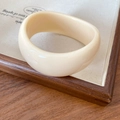 Minimalist chunky acrylic round bangle in a warm cream color with a smooth resin finish - White