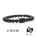 Detail of matte black beads bracelet with golden spacers and Pisces zodiac symbol - Pisces