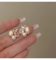 Macro shot of gold geometric earrings with baroque pearls and faceted cubic zirconia stones - Zircon Freshwater Pearl Stud / White