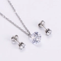 Close-up of sparkling round zircon necklace and stud earrings set in silver finish - Steel Color Chain + White Zirconia