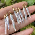 Eight rectangular baroque pearls with gold-plated metal caps held in hand - No.7 Width 4-6mm Length 23-40mm