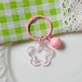 Pink star-shaped acrylic keychain with a matching small bell on a metal ring - Transparent Pink