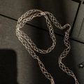 Detailed view of long gold braided necklace with intricate mesh woven texture - Mesh Woven Tassel Style / Silver