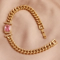 Detail of gold Cuban chain bracelet featuring a rectangular pink zircon and diamond accents - Pink Zirconia
