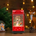 Detail of a vintage red gas pump snow globe featuring a snowman scene and glitter - Gas Pump Snowman and Child