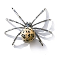 Macro detail of natural spotted stone spider ornament with polished silver metal legs - Irregular Dalmatian Jasper