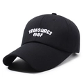 Black cotton baseball cap with white TREASURES 1987 embroidery shown at a 45-degree angle - Adjustable / Black With White Embroidery