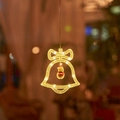 Detail of warm white LED Christmas bell window light with a small snowman figure inside - Warm White Bell