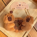 Cute capybara plush keychain duo hugging a bread loaf accessory on a natural wooden tray - Biscuits Duo