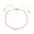 Detail of pink seed bead bracelet with a freshwater pearl and adjustable woven cord - Peach Pink (QQ395A)