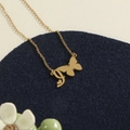 Golden stainless steel butterfly necklace with letter I pendant on blue velvet - Gold J