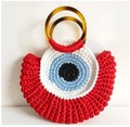Handmade woven tote bag with a unique giant eye design and tortoise shell handles - Big Red with Tassel
