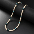 Detailed macro view of handmade beaded necklace with turquoise spacers and beige round beads - Cream Coconut Shell with Black Beads and Turquoise
