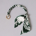 Detail of dark green silk scarf handle with gold metal ring for luxury handbags - Dark Green White Woven Bow / Dark Green White