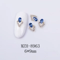 Macro detail of a 6x9mm water drop navy blue gemstone nail charm with diamond border - Gold Base Dark Blue Rhinestone (8963)