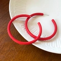 Detailed close-up of red matte acrylic C-shaped hoop earrings on a ceramic dish - Red Matte C-Shaped Large Hoop (52# Silver Pin)