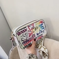 White graffiti crossbody camera bag with colorful street art patterns and wide strap - White
