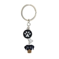 Close-up of metal key ring featuring paw print bone and dog head charms in detail - Doberman