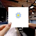 Detailed view of a blue daisy enamel brooch with yellow center and gold plating - 128*Small Blue Daisy Pin