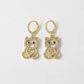 Boucles d'oreilles ours dorées avec zircons blancs et détail cœur sur fond gris - Ours Cœur Zircon