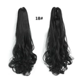 Detail view of 1B black wavy ponytail extension showing the claw clip and texture - Natural Black