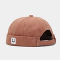 Brick red cotton docker hat featuring a small embroidered smiley face patch on the side - Square Smile Dusty Pink