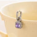 Sparkling silver square earrings with round purple zircon hanging on a ceramic cup - Violet