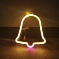 Detail of warm yellow bell-shaped LED neon sign with USB power cable on the floor - Two-color Bell