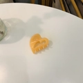 Close-up of a hollow heart-shaped acetate hair claw clip in beige on a white surface - Approx. 4cm / Jelly Orange