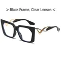 Trendy black frame cat-eye sunglasses with white lenses and gold wavy metal temples - Black Frame Clear Lenses