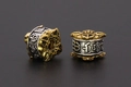 Close-up of retro two-tone alloy beads with embossed Bogu patterns for jewelry making - Eight Auspicious Symbols / 11x11mm