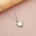 Silver heart locket necklace with love engraving on soft pink textured background - Steel Small Love (22*19mm)