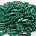 Close-up of natural green malachite crystal points in hexagonal pencil shapes - Malachite