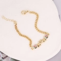 Detailed shot of golden Cuban chain bracelet with colorful zircon heart charms and lobster clasp - Five Rhinestone Hearts (10#)