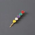 Detailed view of golden metal hair clip with vibrant multi-color rhinestone heart motifs - Multicolor Enamel / Gold Heart