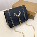 Elegant black quilted chain bag with a decorative golden deer head and tassel accent - Black