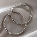 Pair of large silver geometric hoop earrings with twisted texture and faceted design - Twisted Faceted Hoop / Silver