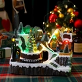 Detailed view of glowing Christmas music box with snowy miniature cabin and LED lights - Double Rotating Christmas Tree Style