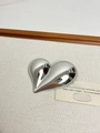 Detailed view of heart-shaped silver brooch with polished finish on textured fabric - 16 Silver Heart Vortex (XZ0010B)