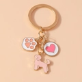 Golden metal keychain featuring cute dog paw, pink heart, and poodle enamel charms - Dog Heart Style
