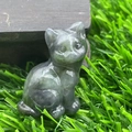 Cute 1.2-inch natural stone cat figurine in dark green polished finish on green grass - Labradorite