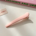 Simple matte pink hair clip for women styled on a pastel pink book in soft natural light - Pink