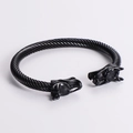 Detail of black twisted cable metal bracelet featuring antique dragon head motifs - Black Cable Black Dragon Head
