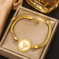 Detail of 18K gold-plated snake chain bracelet with bird pendant on a jewelry box - Gold Snake Chain with Bird (B-42)