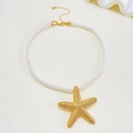 Detail of golden starfish pendant on white braided cord necklace with matte finish - Gold Textured Starfish Necklace (N-507)