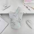 Flat lay of light blue quilted pencil case with bow details on a white desk with stationery - Light Blue